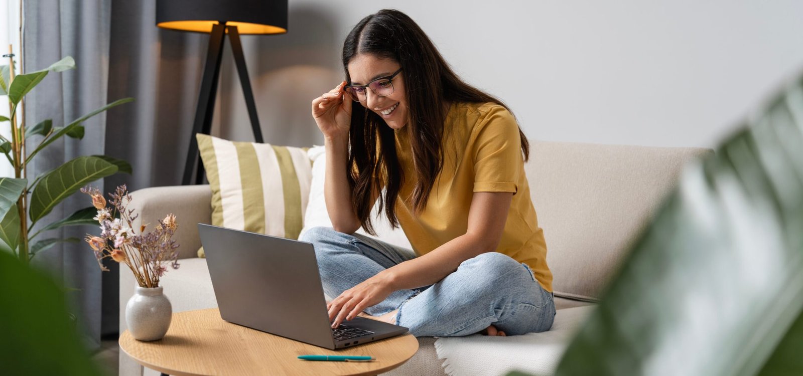 Back to study. Happy student doing her work at home on laptop in a cosy room.